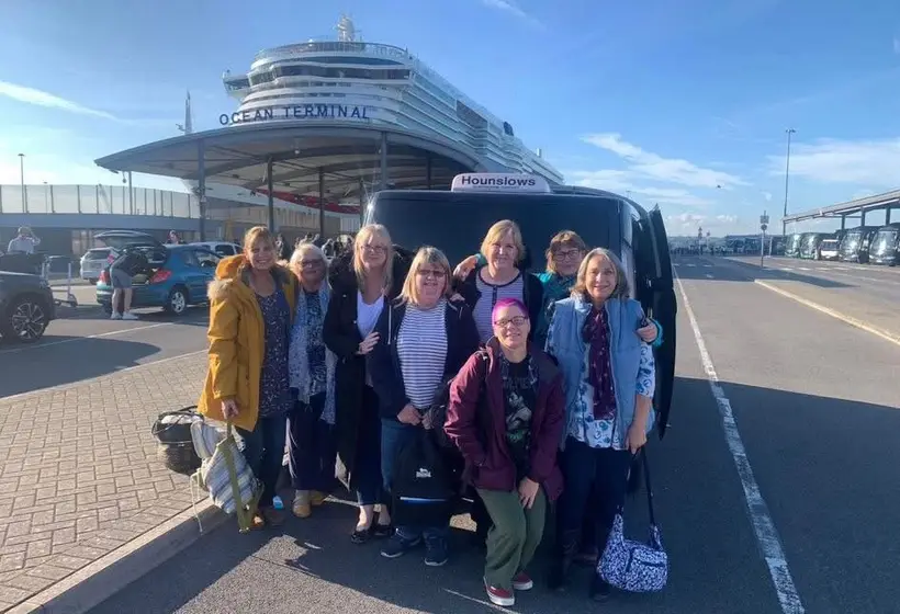 Eight passengers with the car at Southampton Ocean Terminal, a cruise ship behind