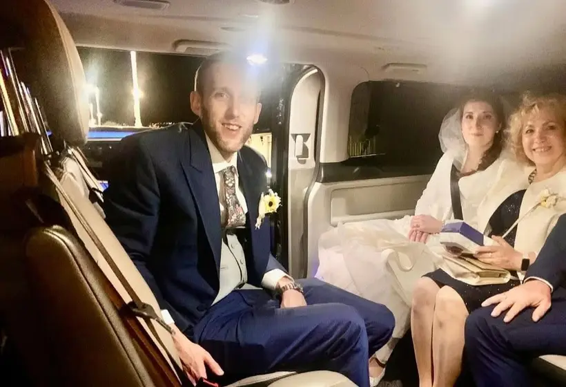 A wedding party in the back of the car